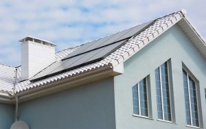 Solar panels on tile roof of grey home
