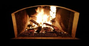 Fireplace burning wood in the dark with atmospheric lighting