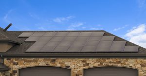 House with solar panels on the roof against blue sky with clouds