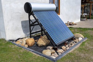 A modern solar pressure collector to heat domestic hot water, standing in front of the house on the lawn.