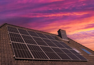 Solar panels producing clean energy on a roof of a residential house 